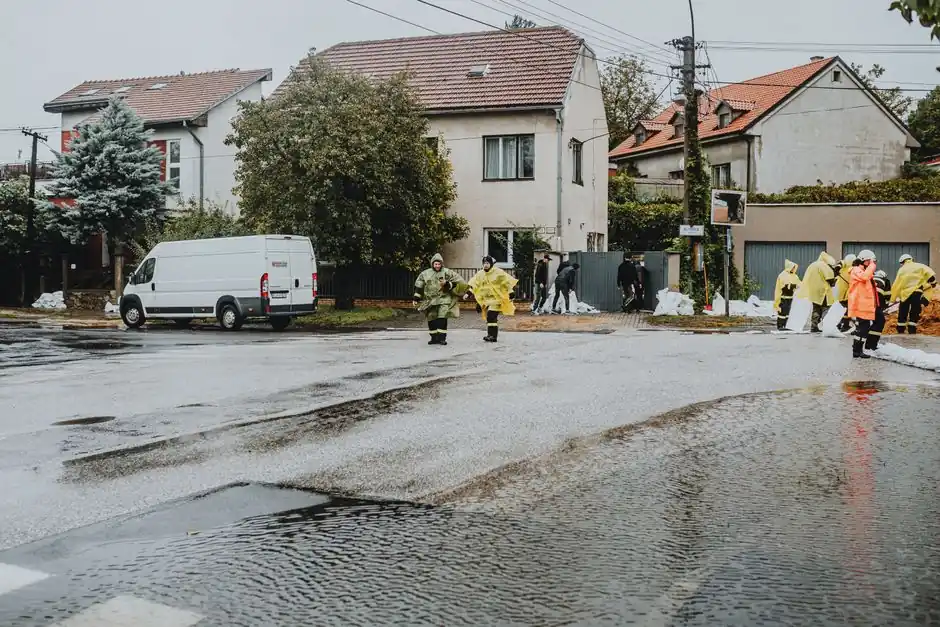 Emergency response team members handle city flooding, deploying sandbags and wearing gear.